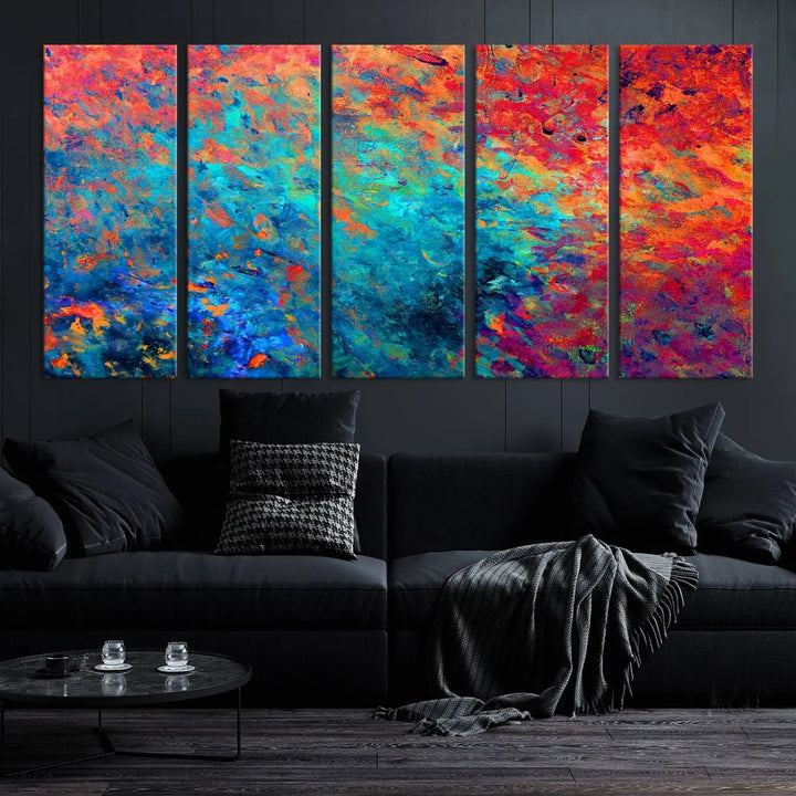 A three-part Colorful Abstract Canvas Wall Art Print, featuring vivid splashes of blue, orange, and red, is showcased on gallery-wrapped, museum-quality canvas with a UV-protective coating.