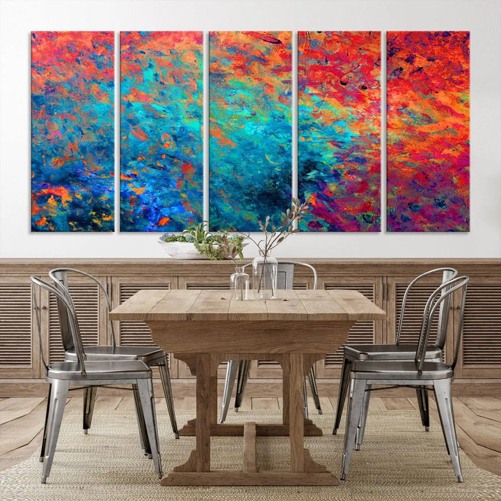 A three-part Colorful Abstract Canvas Wall Art Print, featuring vivid splashes of blue, orange, and red, is showcased on gallery-wrapped, museum-quality canvas with a UV-protective coating.