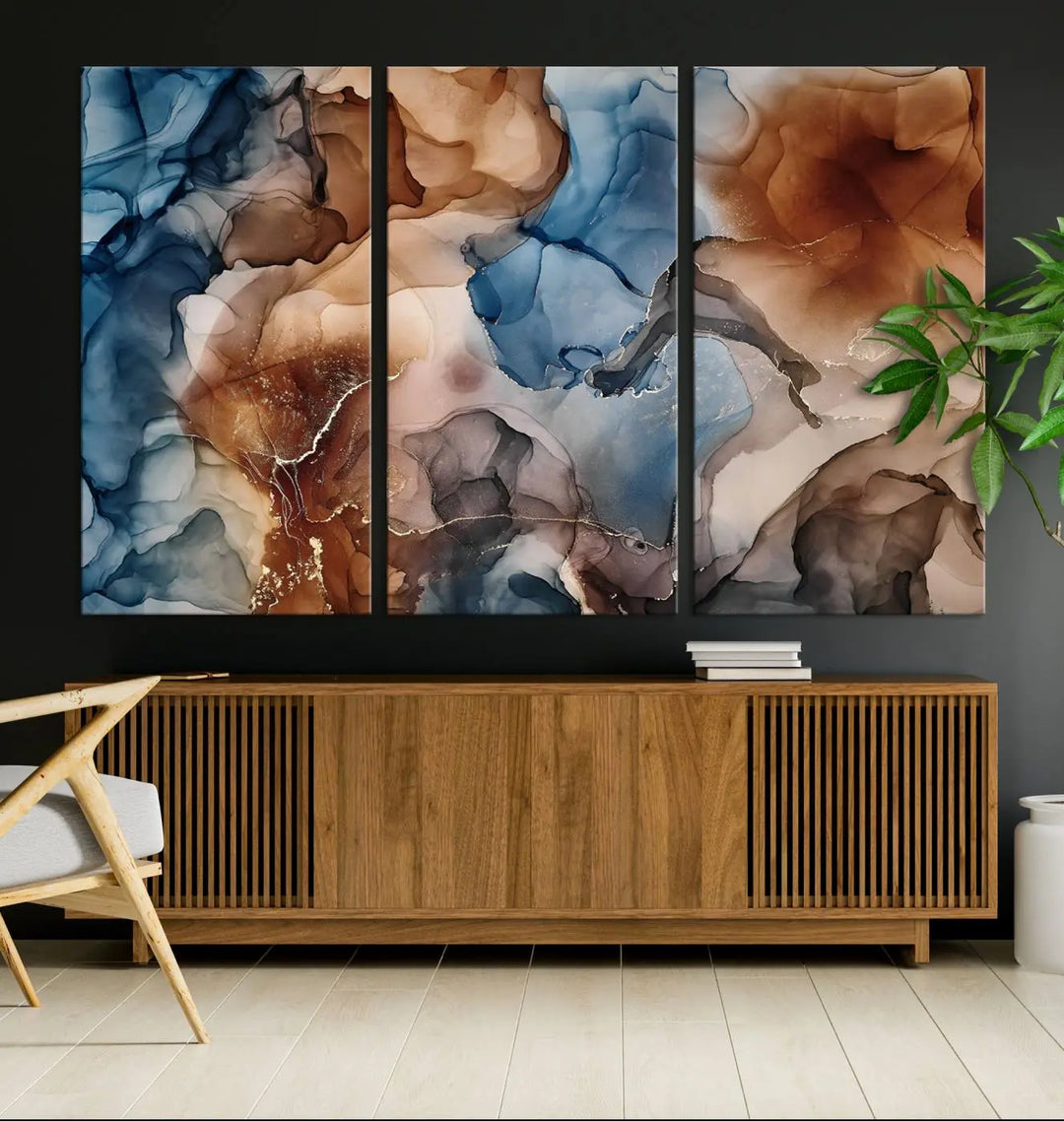 The "Colorful Abstract Clouds Canvas Wall Art Print," featuring an earthy and blue-toned color palette, hangs against a dark wall.