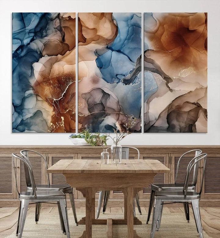 The "Colorful Abstract Clouds Canvas Wall Art Print," featuring an earthy and blue-toned color palette, hangs against a dark wall.