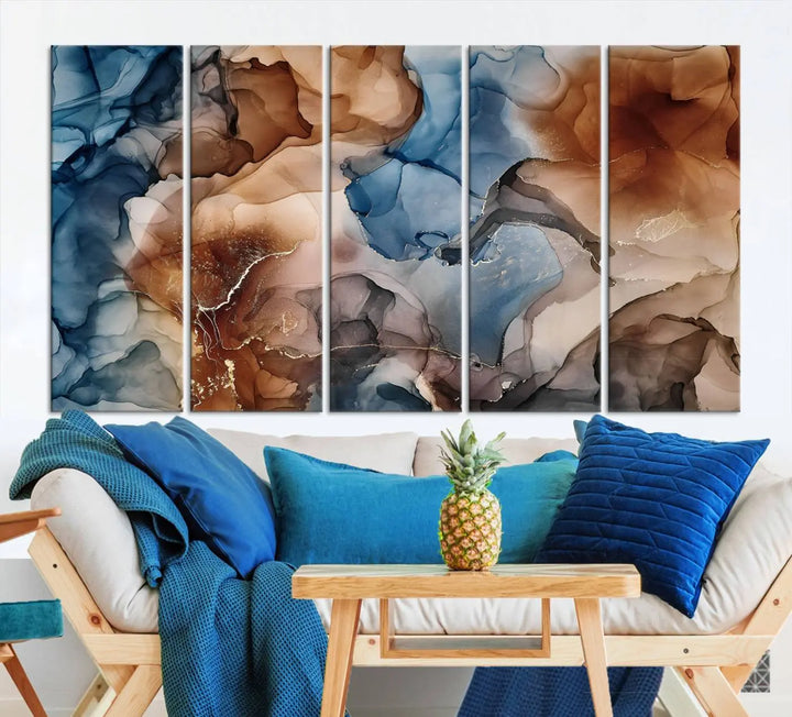 The "Colorful Abstract Clouds Canvas Wall Art Print," featuring an earthy and blue-toned color palette, hangs against a dark wall.