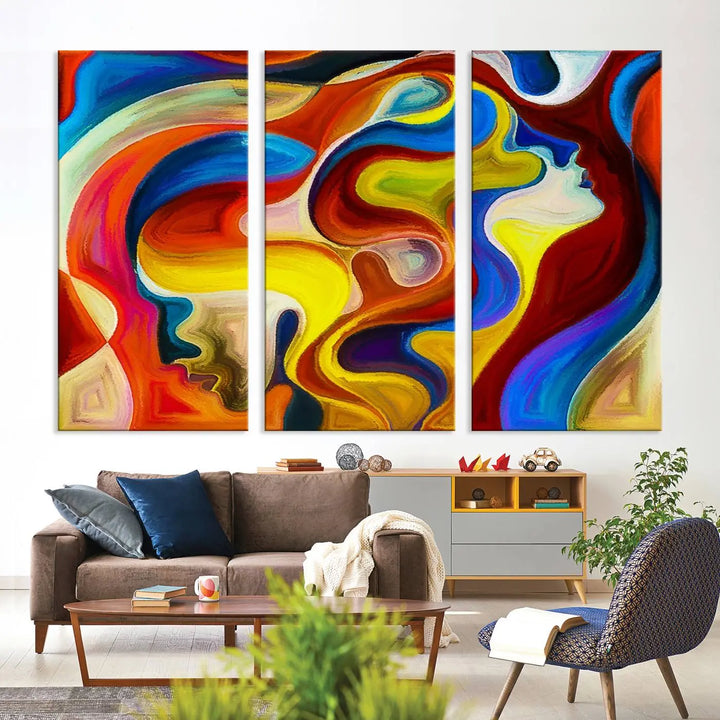 The Colorful Abstract Human Figure Wall Art Canvas Print, featuring overlapping human profiles on museum-quality canvas, is exhibited as a triptych.