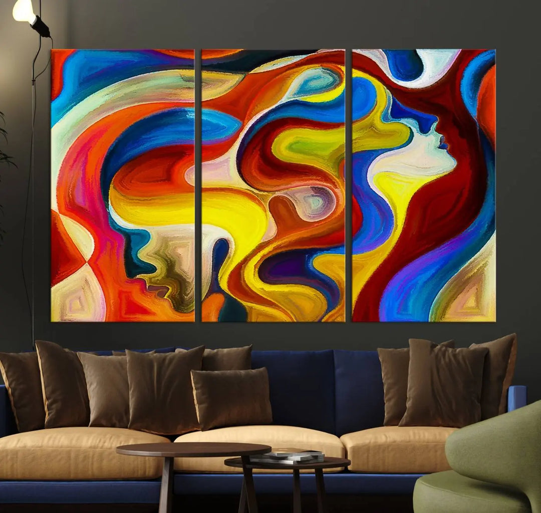 The Colorful Abstract Human Figure Wall Art Canvas Print, featuring overlapping human profiles on museum-quality canvas, is exhibited as a triptych.