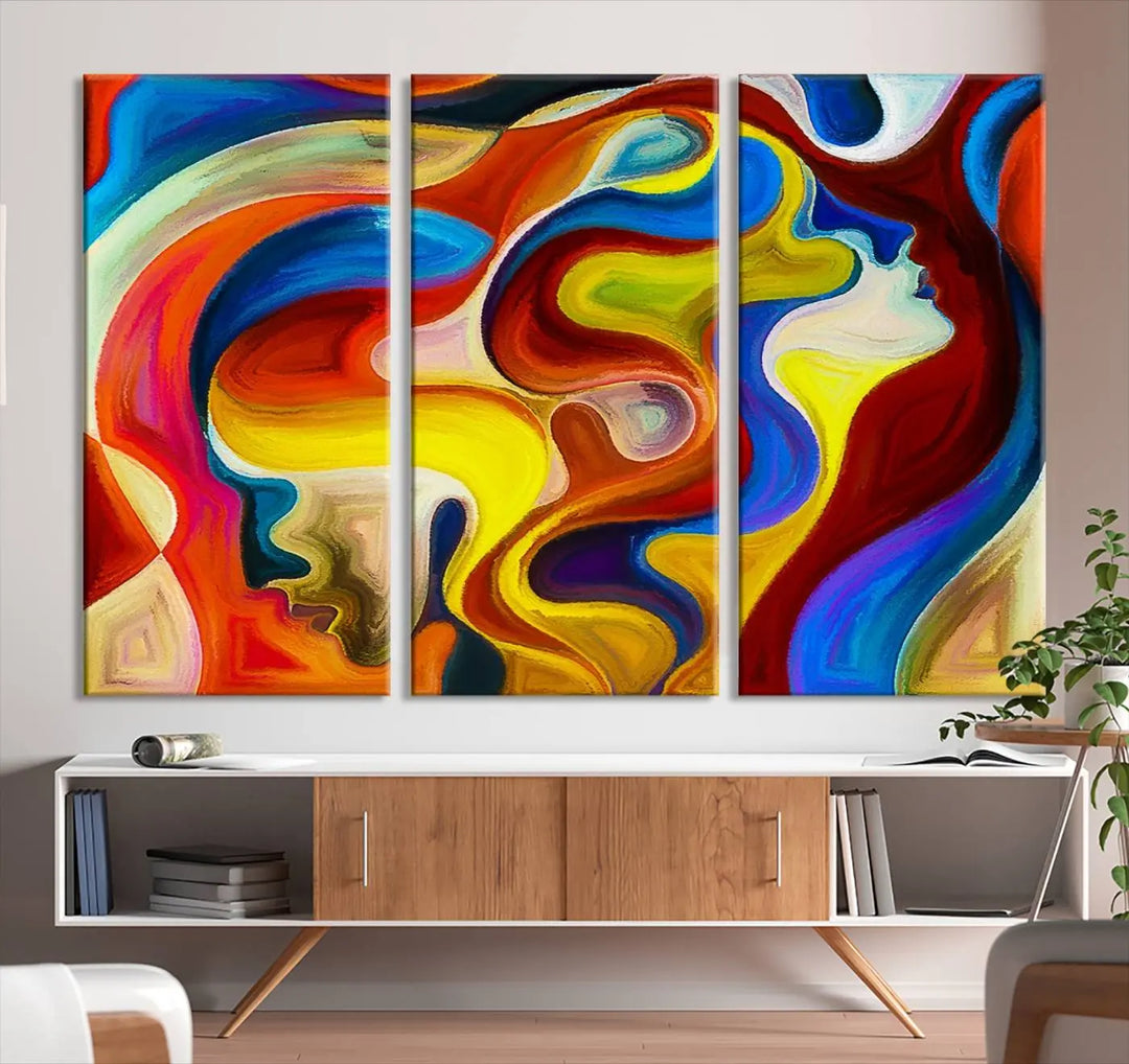 The Colorful Abstract Human Figure Wall Art Canvas Print, featuring overlapping human profiles on museum-quality canvas, is exhibited as a triptych.