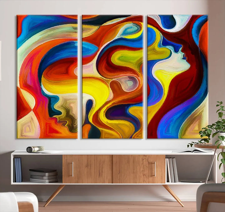 The Colorful Abstract Human Figure Wall Art Canvas Print, featuring overlapping human profiles on museum-quality canvas, is exhibited as a triptych.