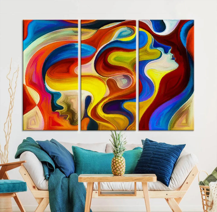 The Colorful Abstract Human Figure Wall Art Canvas Print, featuring overlapping human profiles on museum-quality canvas, is exhibited as a triptych.