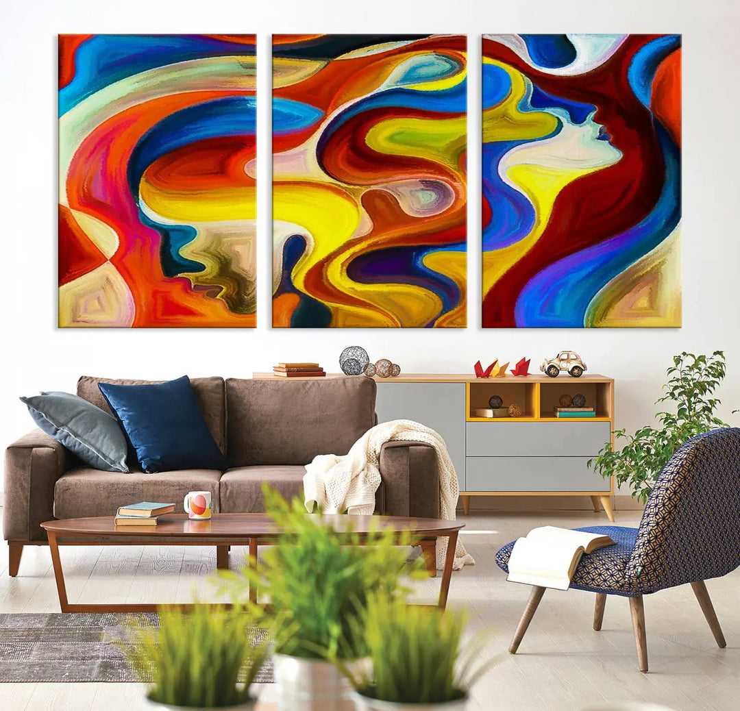 The Colorful Abstract Human Figure Wall Art Canvas Print, featuring overlapping human profiles on museum-quality canvas, is exhibited as a triptych.