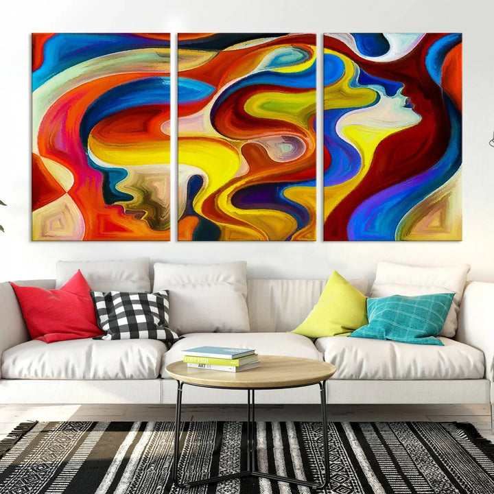 The Colorful Abstract Human Figure Wall Art Canvas Print, featuring overlapping human profiles on museum-quality canvas, is exhibited as a triptych.