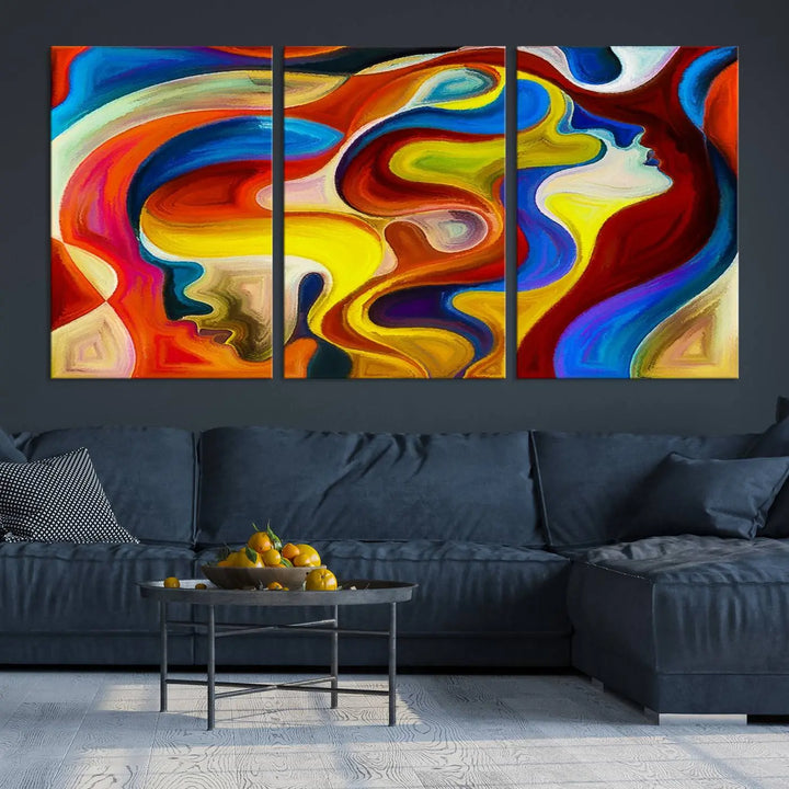 The Colorful Abstract Human Figure Wall Art Canvas Print, featuring overlapping human profiles on museum-quality canvas, is exhibited as a triptych.