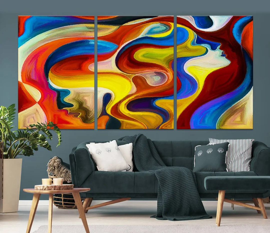 The Colorful Abstract Human Figure Wall Art Canvas Print, featuring overlapping human profiles on museum-quality canvas, is exhibited as a triptych.