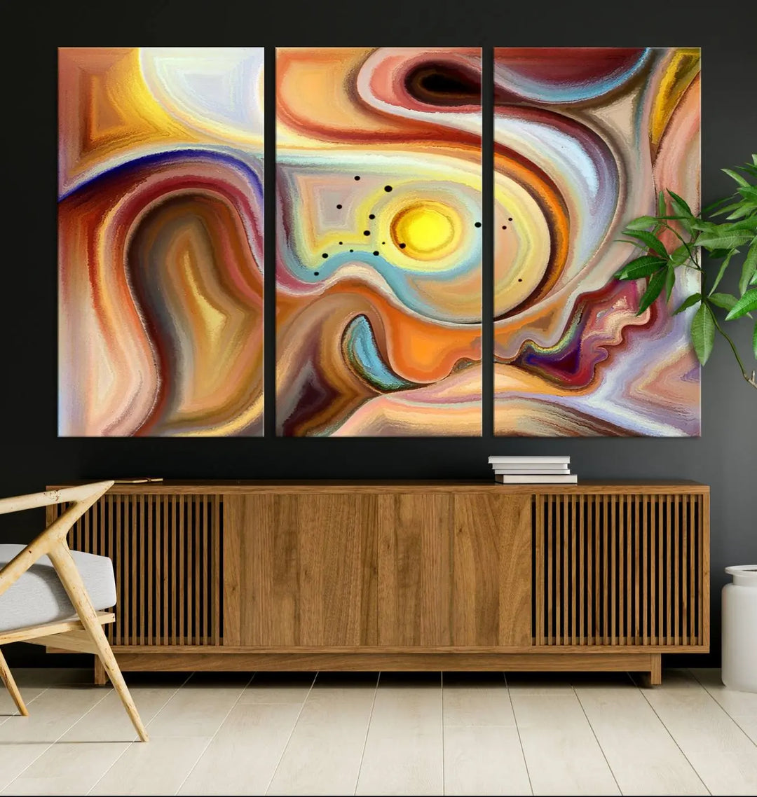 The "Colorful Abstract Human Figures Wall Art Canvas Print" features a triptych design with swirling colors in yellow, brown, and orange tones on gallery-wrapped, museum-quality canvases.