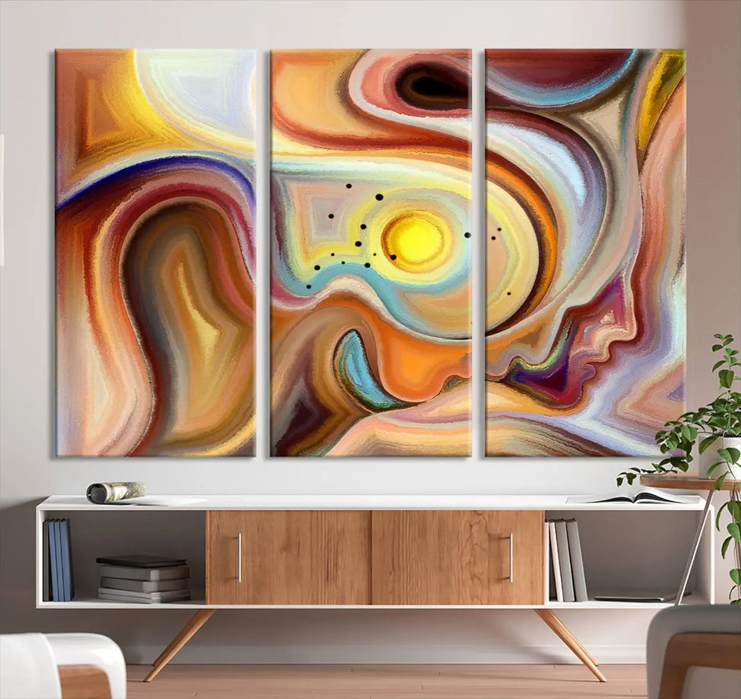 The "Colorful Abstract Human Figures Wall Art Canvas Print" features a triptych design with swirling colors in yellow, brown, and orange tones on gallery-wrapped, museum-quality canvases.