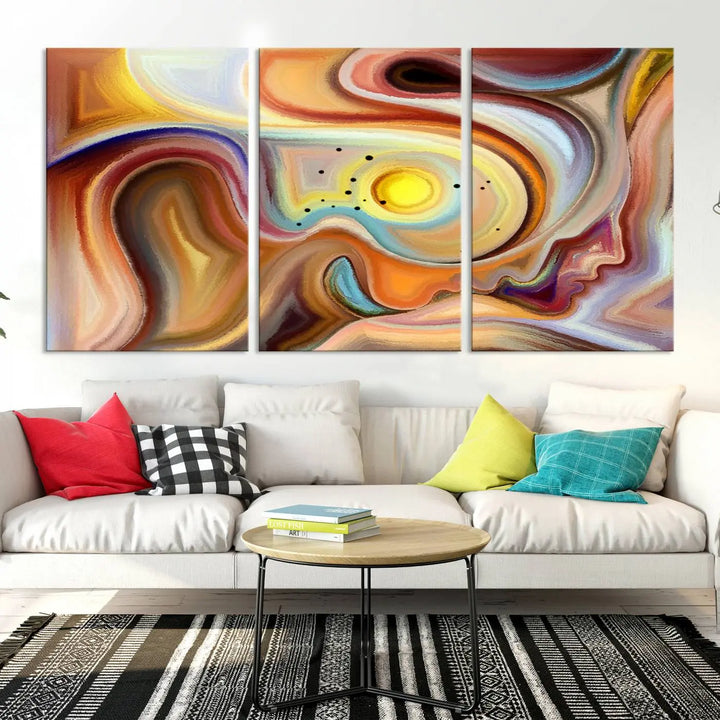 The "Colorful Abstract Human Figures Wall Art Canvas Print" features a triptych design with swirling colors in yellow, brown, and orange tones on gallery-wrapped, museum-quality canvases.