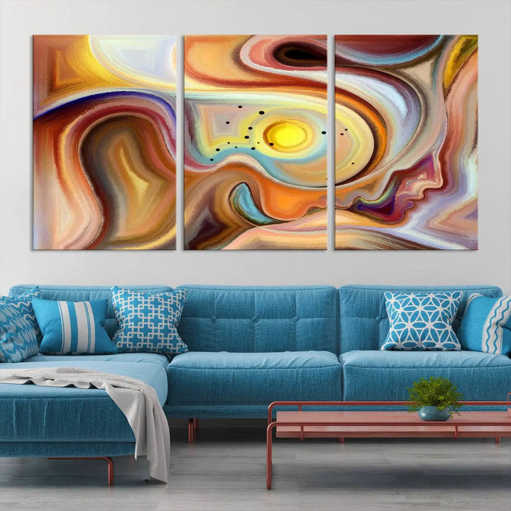 The "Colorful Abstract Human Figures Wall Art Canvas Print" features a triptych design with swirling colors in yellow, brown, and orange tones on gallery-wrapped, museum-quality canvases.