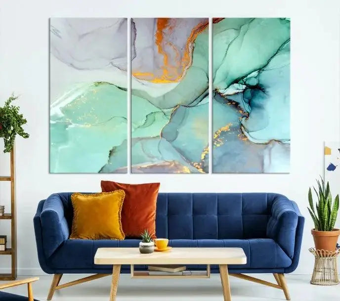 Contemporary living room featuring the Colorful Marble Fluid Effect Wall Art Abstract Canvas Wall Art Print, showcasing multi-panel abstract designs in teal, gold, and white tones. This museum-quality canvas artwork is ready to hang and finished with a UV-protective coating for enduring vibrancy.