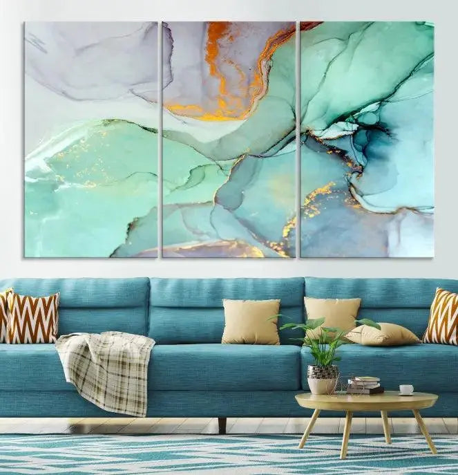 Contemporary living room featuring the Colorful Marble Fluid Effect Wall Art Abstract Canvas Wall Art Print, showcasing multi-panel abstract designs in teal, gold, and white tones. This museum-quality canvas artwork is ready to hang and finished with a UV-protective coating for enduring vibrancy.