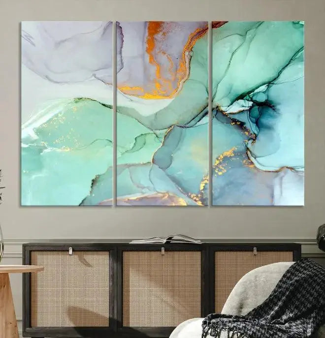 Contemporary living room featuring the Colorful Marble Fluid Effect Wall Art Abstract Canvas Wall Art Print, showcasing multi-panel abstract designs in teal, gold, and white tones. This museum-quality canvas artwork is ready to hang and finished with a UV-protective coating for enduring vibrancy.