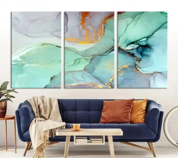 Contemporary living room featuring the Colorful Marble Fluid Effect Wall Art Abstract Canvas Wall Art Print, showcasing multi-panel abstract designs in teal, gold, and white tones. This museum-quality canvas artwork is ready to hang and finished with a UV-protective coating for enduring vibrancy.