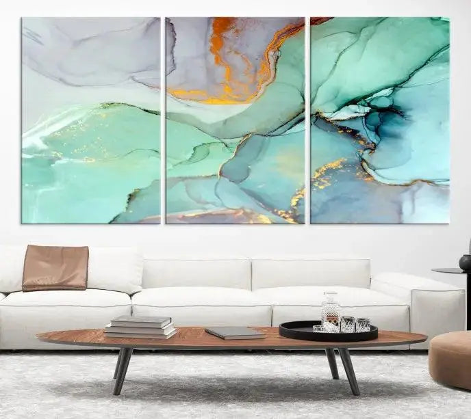 Contemporary living room featuring the Colorful Marble Fluid Effect Wall Art Abstract Canvas Wall Art Print, showcasing multi-panel abstract designs in teal, gold, and white tones. This museum-quality canvas artwork is ready to hang and finished with a UV-protective coating for enduring vibrancy.