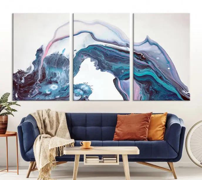 A stunning triptych of the "Colorful Marble Fluid Effect Wall Art Abstract Canvas Wall Art Print" in blue and purple hues hangs prominently in this modern living room.