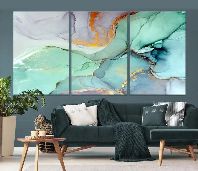 Contemporary living room featuring the Colorful Marble Fluid Effect Wall Art Abstract Canvas Wall Art Print, showcasing multi-panel abstract designs in teal, gold, and white tones. This museum-quality canvas artwork is ready to hang and finished with a UV-protective coating for enduring vibrancy.