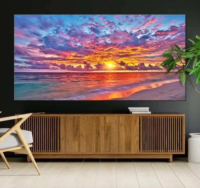 The Colorful Sunset Seashore Wall Art Canvas Print, featuring a triptych of a vibrant ocean sunset on gallery-wrapped museum-quality canvas, adorns the wall.