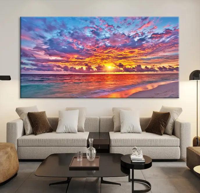 The Colorful Sunset Seashore Wall Art Canvas Print, featuring a triptych of a vibrant ocean sunset on gallery-wrapped museum-quality canvas, adorns the wall.