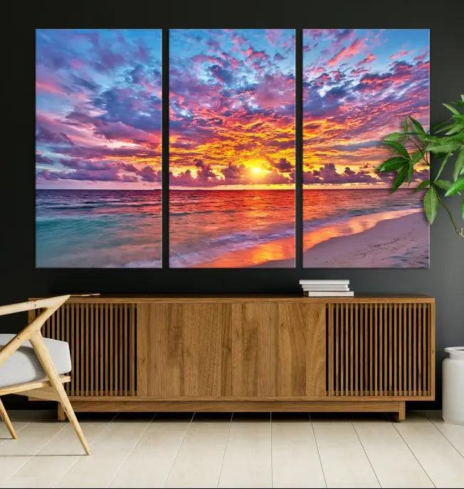 The Colorful Sunset Seashore Wall Art Canvas Print, featuring a triptych of a vibrant ocean sunset on gallery-wrapped museum-quality canvas, adorns the wall.