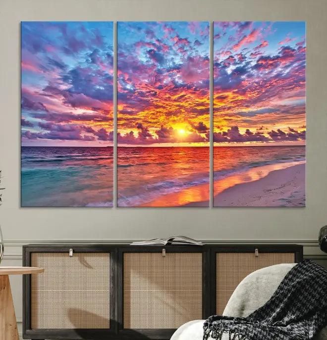 The Colorful Sunset Seashore Wall Art Canvas Print, featuring a triptych of a vibrant ocean sunset on gallery-wrapped museum-quality canvas, adorns the wall.