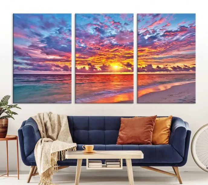 The Colorful Sunset Seashore Wall Art Canvas Print, featuring a triptych of a vibrant ocean sunset on gallery-wrapped museum-quality canvas, adorns the wall.