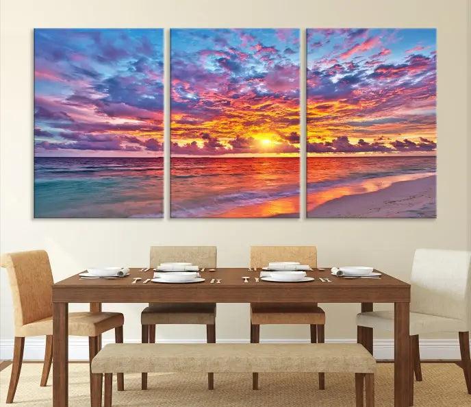 The Colorful Sunset Seashore Wall Art Canvas Print, featuring a triptych of a vibrant ocean sunset on gallery-wrapped museum-quality canvas, adorns the wall.