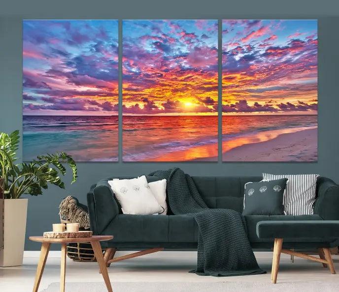 The Colorful Sunset Seashore Wall Art Canvas Print, featuring a triptych of a vibrant ocean sunset on gallery-wrapped museum-quality canvas, adorns the wall.