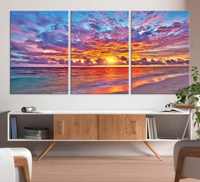 The Colorful Sunset Seashore Wall Art Canvas Print, featuring a triptych of a vibrant ocean sunset on gallery-wrapped museum-quality canvas, adorns the wall.