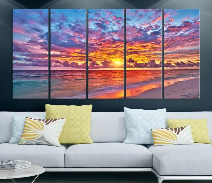 The Colorful Sunset Seashore Wall Art Canvas Print, featuring a triptych of a vibrant ocean sunset on gallery-wrapped museum-quality canvas, adorns the wall.