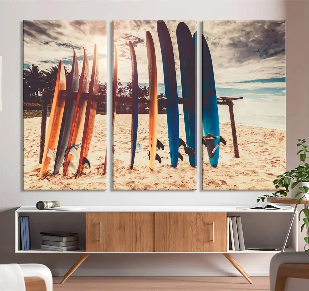 A three-panel canvas wall art titled "Colorful Surfing Boards and Sunset Canvas Wall Art Print Canvas Print" features surfboards on a sandy beach. This piece is crafted on gallery-wrapped, museum-quality canvas with a UV-protective coating.