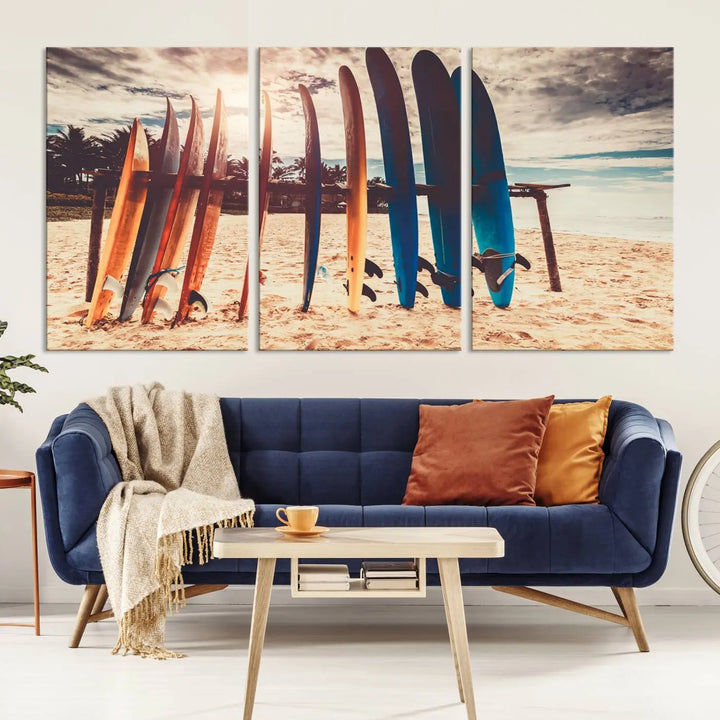 A three-panel canvas wall art titled "Colorful Surfing Boards and Sunset Canvas Wall Art Print Canvas Print" features surfboards on a sandy beach. This piece is crafted on gallery-wrapped, museum-quality canvas with a UV-protective coating.