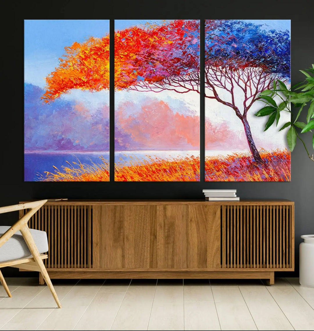 The Colorful Tree Wall Art Canvas is a vibrant, multi-panel painting depicting a colorful tree by a lake. It is crafted on museum-quality canvas and comes ready to hang.