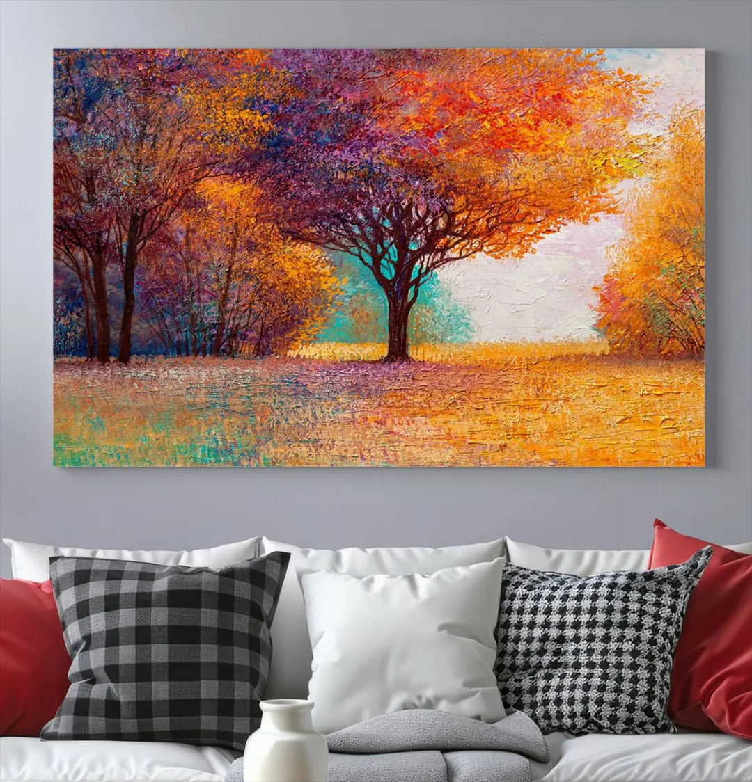 The "Colorful Tree in Autumn" wall art canvas print features a three-panel depiction of a vibrant autumn landscape, gallery wrapped on museum-quality polycotton with UV-protective coating, enhancing the wall in a stylish living room.