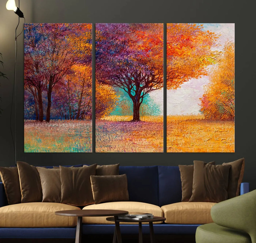 The "Colorful Tree in Autumn" wall art canvas print features a three-panel depiction of a vibrant autumn landscape, gallery wrapped on museum-quality polycotton with UV-protective coating, enhancing the wall in a stylish living room.