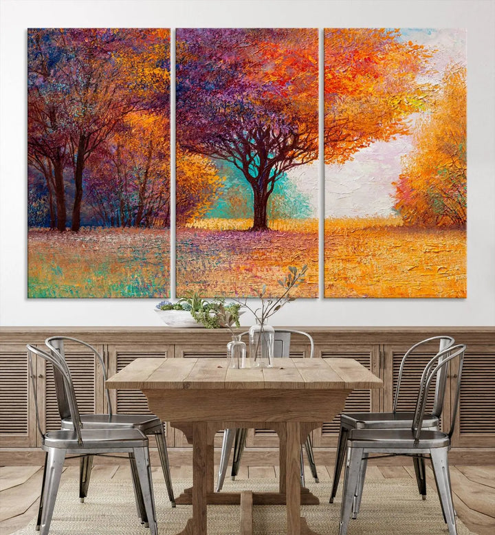 The "Colorful Tree in Autumn" wall art canvas print features a three-panel depiction of a vibrant autumn landscape, gallery wrapped on museum-quality polycotton with UV-protective coating, enhancing the wall in a stylish living room.