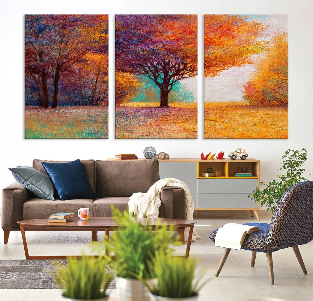 The "Colorful Tree in Autumn" wall art canvas print features a three-panel depiction of a vibrant autumn landscape, gallery wrapped on museum-quality polycotton with UV-protective coating, enhancing the wall in a stylish living room.