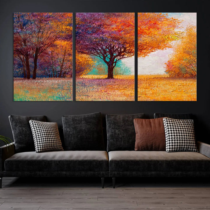 The "Colorful Tree in Autumn" wall art canvas print features a three-panel depiction of a vibrant autumn landscape, gallery wrapped on museum-quality polycotton with UV-protective coating, enhancing the wall in a stylish living room.