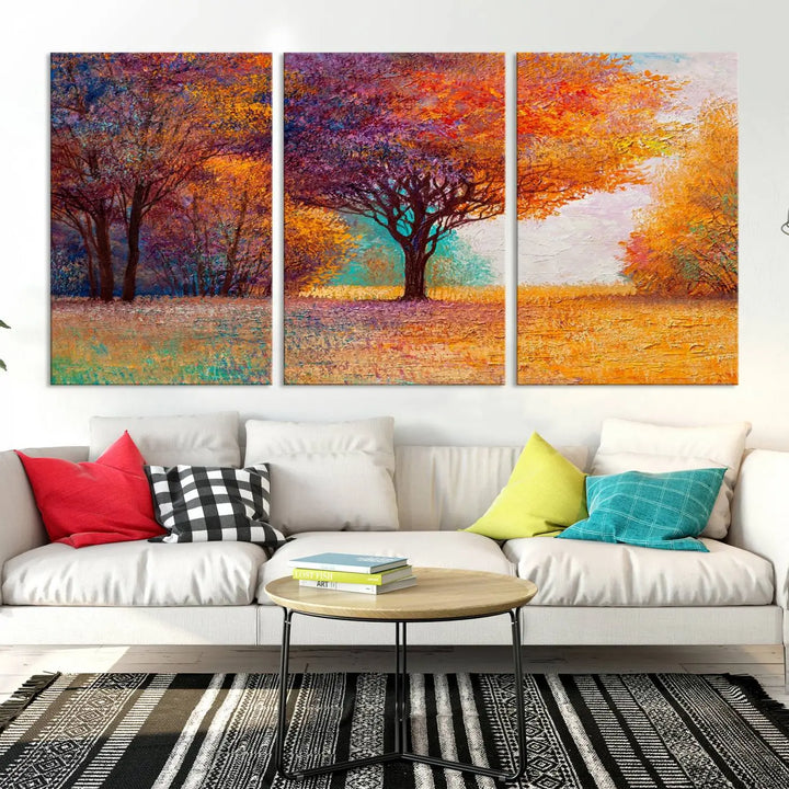 The "Colorful Tree in Autumn" wall art canvas print features a three-panel depiction of a vibrant autumn landscape, gallery wrapped on museum-quality polycotton with UV-protective coating, enhancing the wall in a stylish living room.