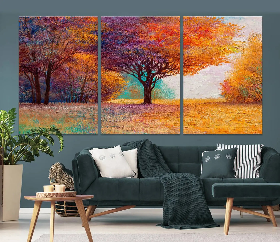 The "Colorful Tree in Autumn" wall art canvas print features a three-panel depiction of a vibrant autumn landscape, gallery wrapped on museum-quality polycotton with UV-protective coating, enhancing the wall in a stylish living room.