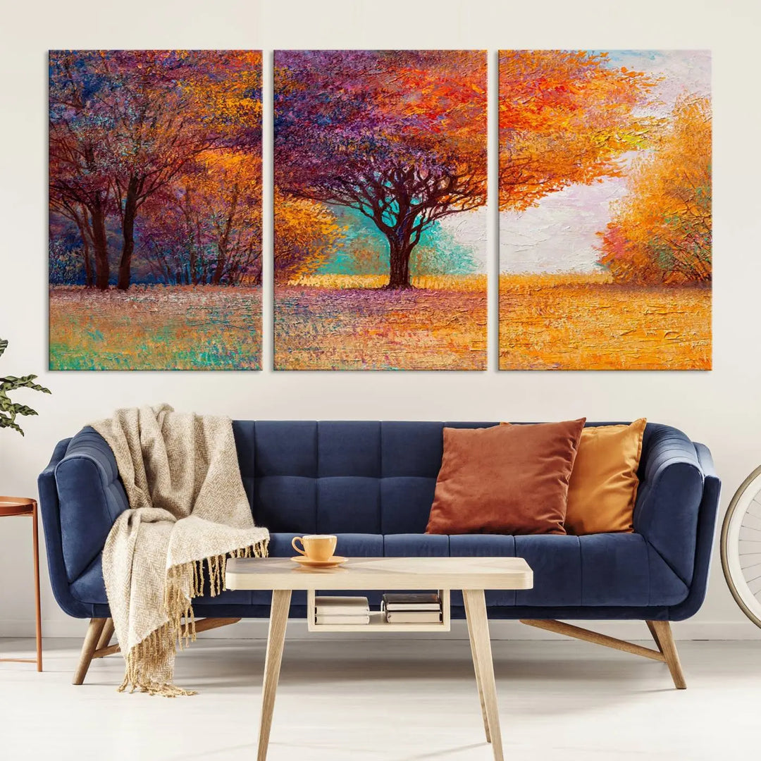 The "Colorful Tree in Autumn" wall art canvas print features a three-panel depiction of a vibrant autumn landscape, gallery wrapped on museum-quality polycotton with UV-protective coating, enhancing the wall in a stylish living room.