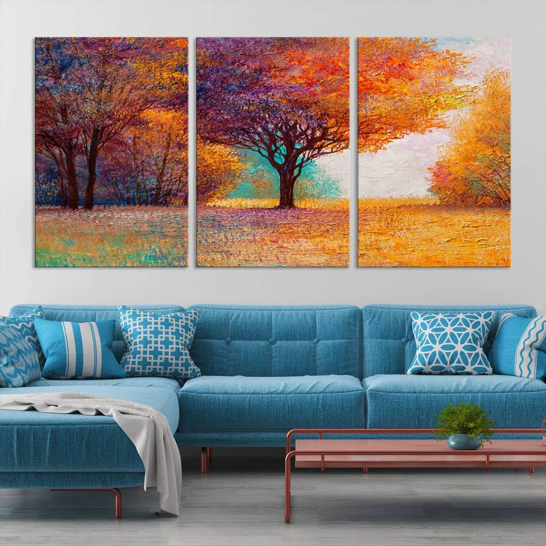 The "Colorful Tree in Autumn" wall art canvas print features a three-panel depiction of a vibrant autumn landscape, gallery wrapped on museum-quality polycotton with UV-protective coating, enhancing the wall in a stylish living room.