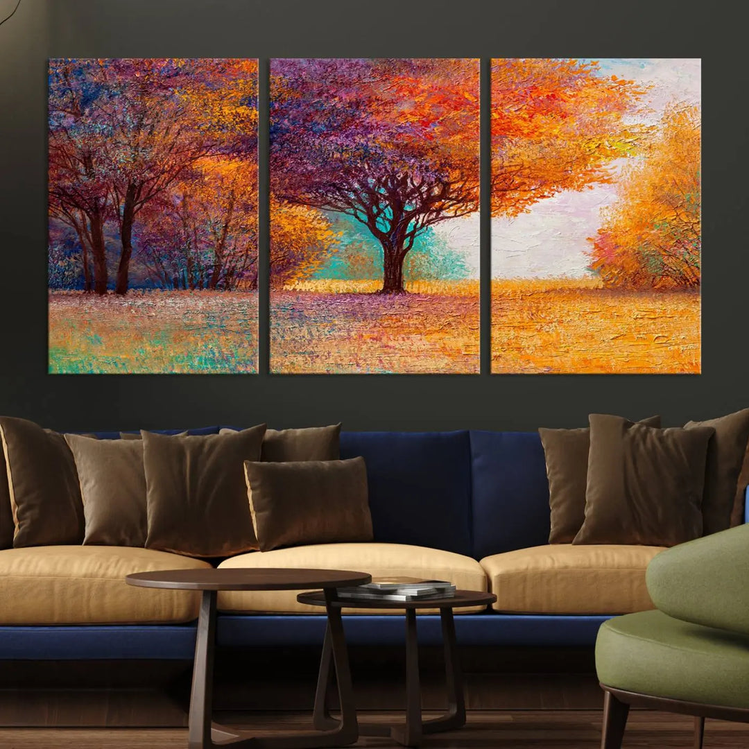 The "Colorful Tree in Autumn" wall art canvas print features a three-panel depiction of a vibrant autumn landscape, gallery wrapped on museum-quality polycotton with UV-protective coating, enhancing the wall in a stylish living room.