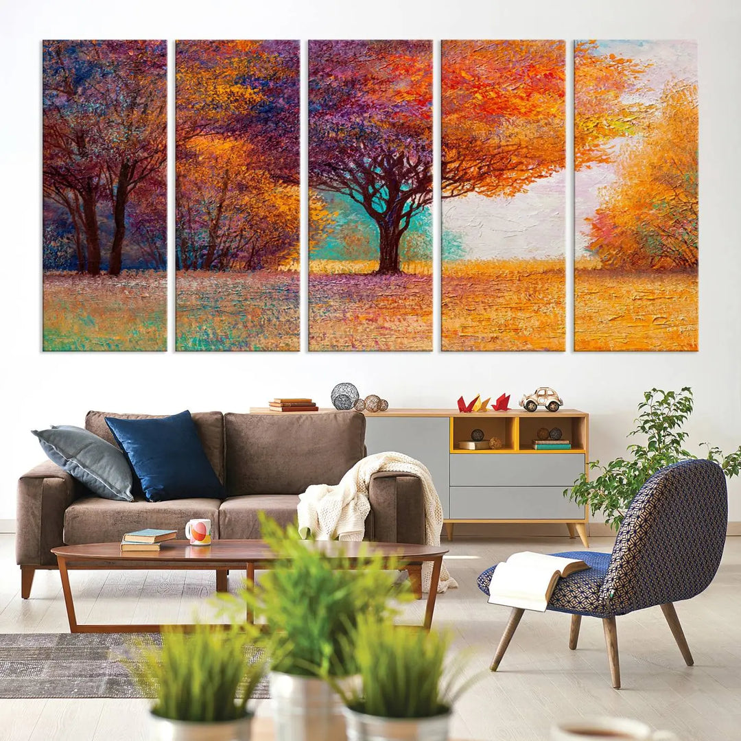 The "Colorful Tree in Autumn" wall art canvas print features a three-panel depiction of a vibrant autumn landscape, gallery wrapped on museum-quality polycotton with UV-protective coating, enhancing the wall in a stylish living room.