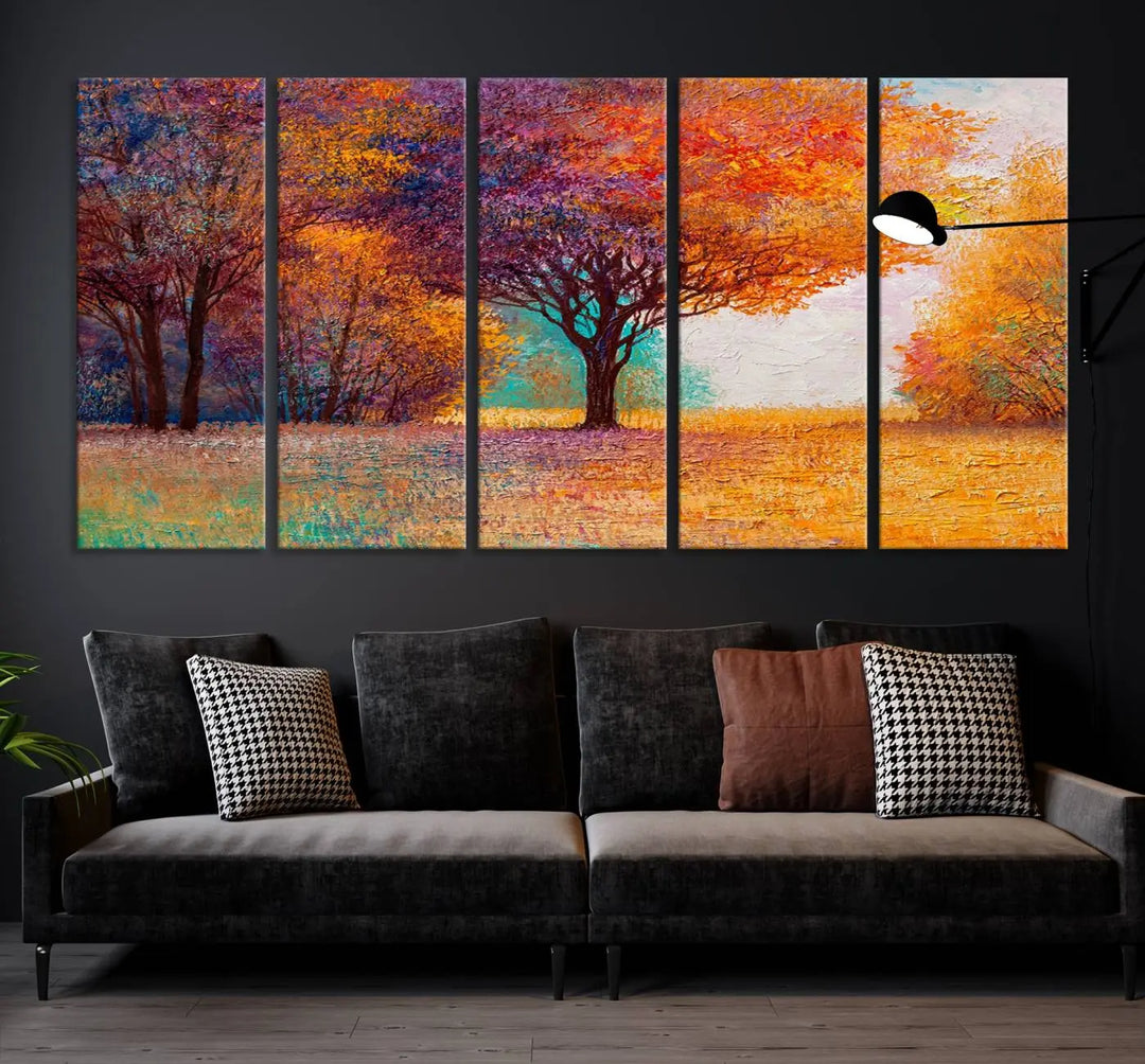 The "Colorful Tree in Autumn" wall art canvas print features a three-panel depiction of a vibrant autumn landscape, gallery wrapped on museum-quality polycotton with UV-protective coating, enhancing the wall in a stylish living room.