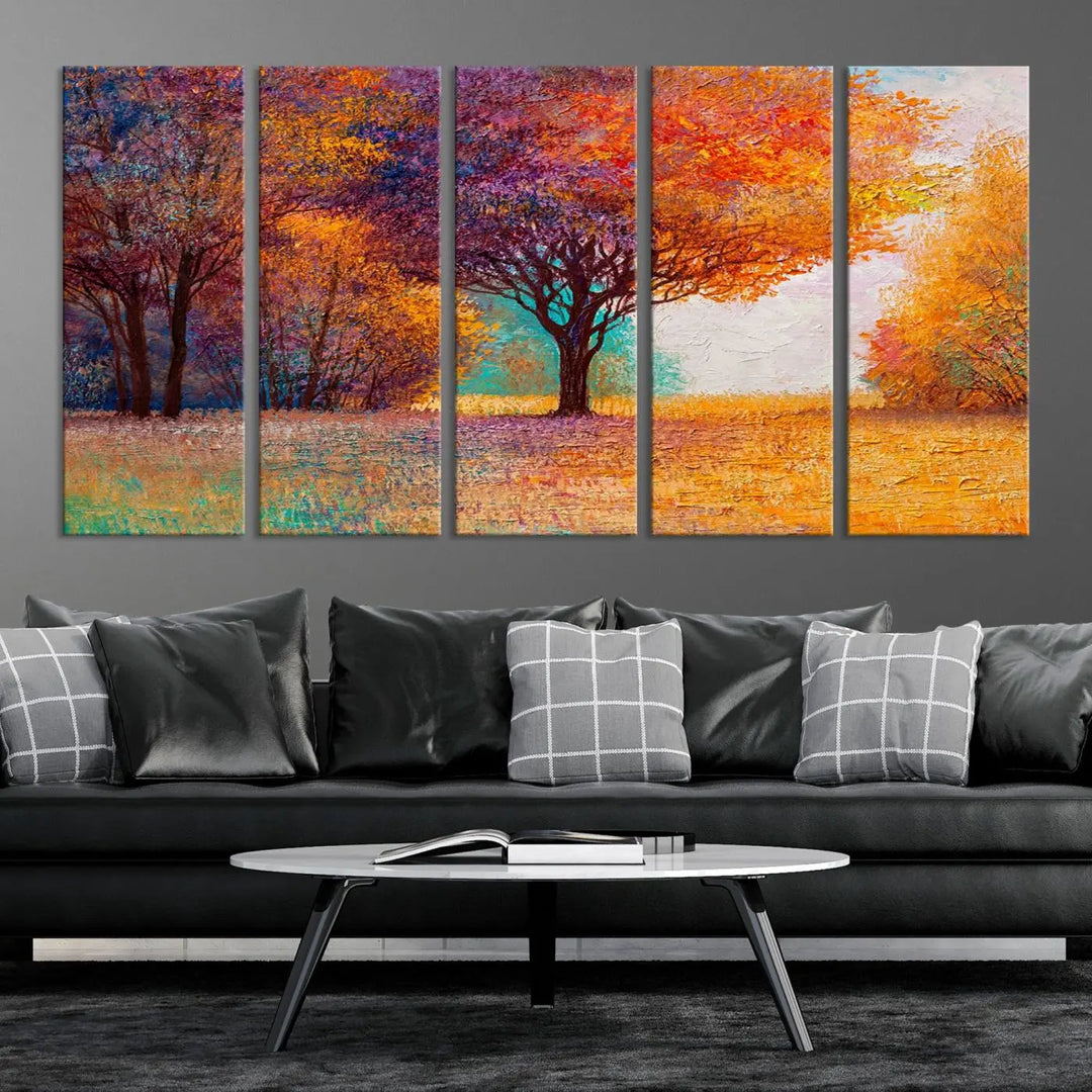 The "Colorful Tree in Autumn" wall art canvas print features a three-panel depiction of a vibrant autumn landscape, gallery wrapped on museum-quality polycotton with UV-protective coating, enhancing the wall in a stylish living room.